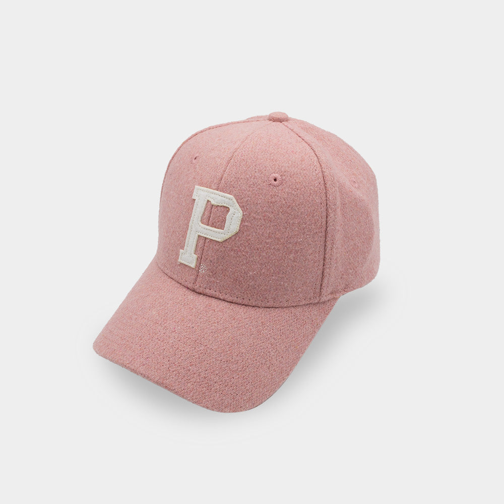 The Portland "P" Cap - Classic features a pink design with a white, embroidered letter "P" on the front. It has a curved brim and visible stitching that give it a textured look. This vintage strap hat is delivered in sustainable packaging against a plain white background.