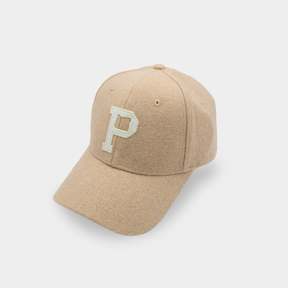 The Portland "P" Cap - Tan features a prominent white letter "P" on the front. This SHELL PRODUCT comes with a curved brim and textured fabric, offering a stylish and casual look.