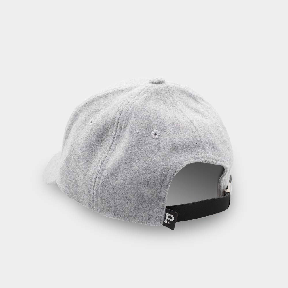 The Portland "P" Cap - Classic is depicted from the back. It showcases an adjustable black strap with a brass buckle and a white embroidered letter "P" on the strap. This vintage six-panel hat includes eyelets for ventilation in a light gray color.