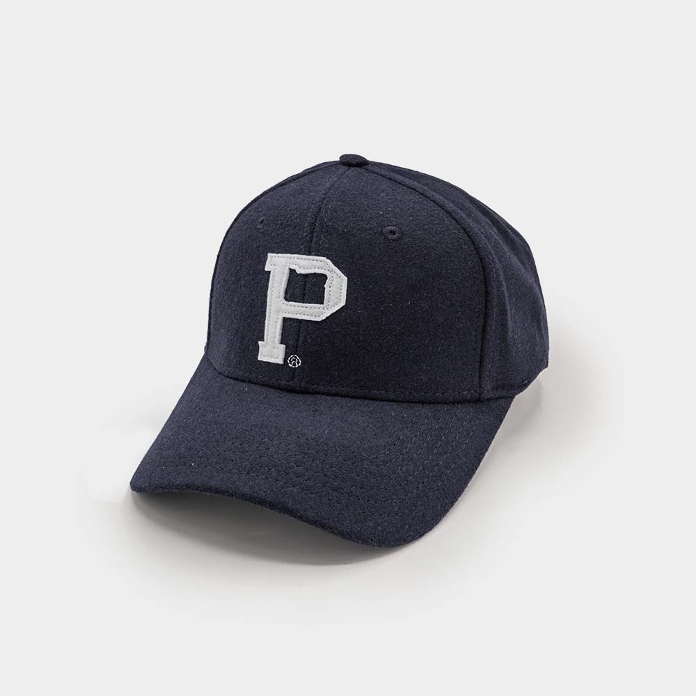 The Portland "P" Cap - Classic is a black baseball cap with a white letter "P" embroidered on the front. Featuring a curved visor and an adjustable vintage strap at the back, it is showcased against a plain white background, highlighting its timeless design.