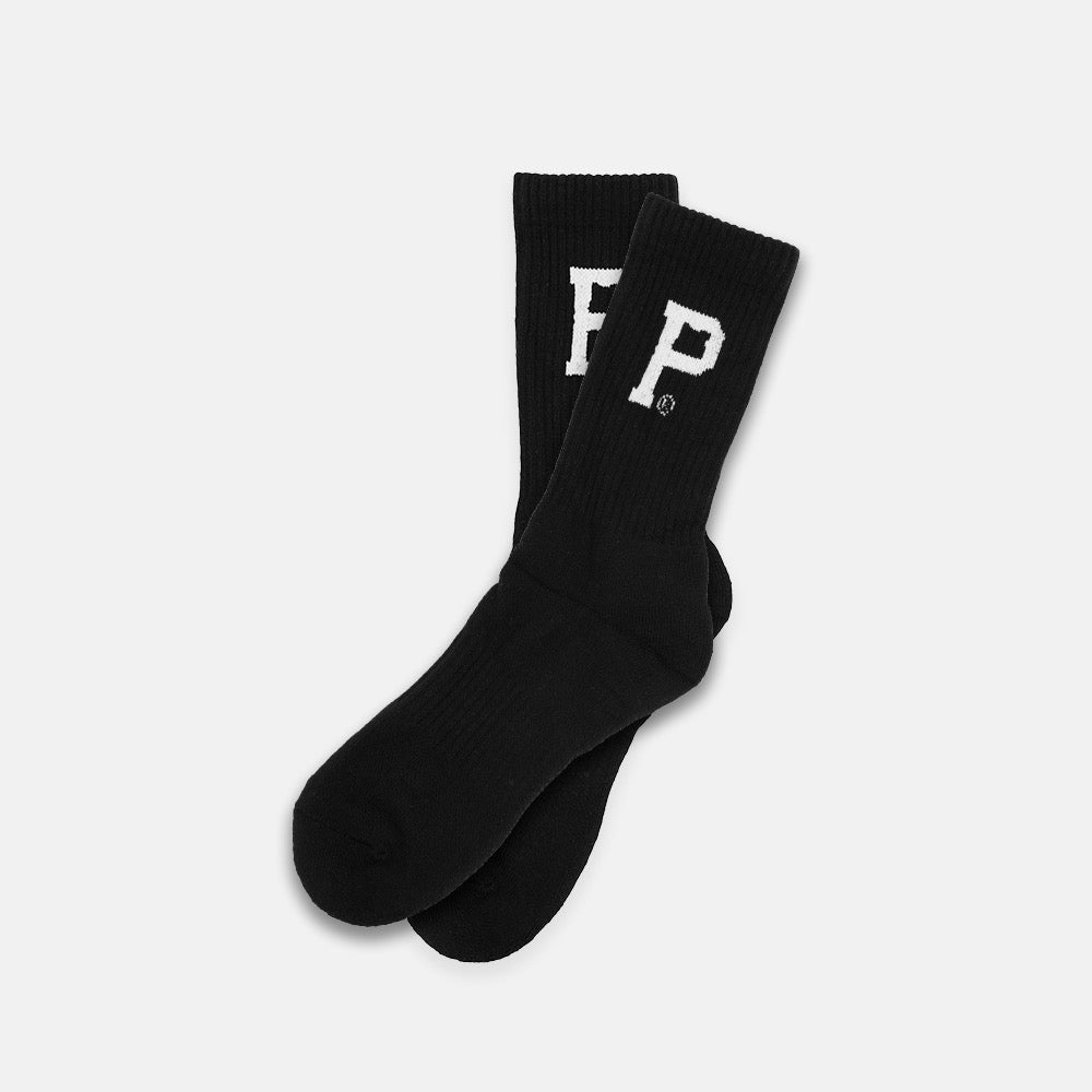 A pair of Portland Gear Core Socks in black, featuring thick ribbed cuffs and a bold white letter "P" on the side. The socks are displayed laid flat and slightly overlapping against a plain white background. They are machine washable and come in sustainable packaging.